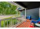 Relaxing front porch with vibrant seating, a view of the green surroundings and a wood deck at 6933 Grey Wolf Dr, , IN 46164