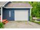 Attached garage with a white door, side door, and driveway parking at 6933 Grey Wolf Dr, , IN 46164