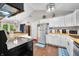 Well-lit kitchen features stainless steel appliances, white cabinetry and views of the dining area at 6933 Grey Wolf Dr, , IN 46164