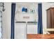 Convenient laundry area featuring side-by-side washer and dryer units behind blue curtains at 6933 Grey Wolf Dr, , IN 46164