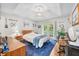 Bright bedroom with a tray ceiling, white walls, an area rug, and exterior access at 6933 Grey Wolf Dr, , IN 46164