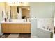 Well-lit bathroom featuring a double sink vanity, tub, and neutral decor, perfect for relaxation and functionality at 7042 Gavin Dr, Indianapolis, IN 46217