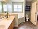 Bathroom featuring double sinks, tile floor and separate tub at 7042 Gavin Dr, Indianapolis, IN 46217