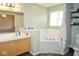 Relaxing bathroom features a vanity, tub and neutral decor, creating a spa-like retreat in your own home at 7042 Gavin Dr, Indianapolis, IN 46217