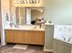 Bathroom featuring double sinks, tile floor and separate tub at 7042 Gavin Dr, Indianapolis, IN 46217