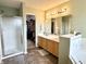 Bathroom featuring double sinks, tile floor, walk-in shower and separate tub at 7042 Gavin Dr, Indianapolis, IN 46217