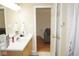 Bright bathroom showcasing a vanity, mirror, and open doorway leading to the living area at 7042 Gavin Dr, Indianapolis, IN 46217