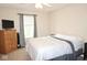 Comfortable bedroom featuring a queen-sized bed, dresser, and window with natural light at 7042 Gavin Dr, Indianapolis, IN 46217