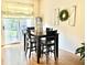 Dining area with dark wood table, view to back deck through sliding glass door at 7042 Gavin Dr, Indianapolis, IN 46217