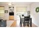 Open-concept dining area with a dining table, adjacent to the living room and patio doors at 7042 Gavin Dr, Indianapolis, IN 46217