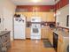 Bright kitchen featuring light wood cabinetry, white appliances, and functional layout at 7042 Gavin Dr, Indianapolis, IN 46217