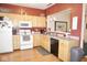 L-shaped kitchen with ample cabinet space, neutral countertops, and modern appliances at 7042 Gavin Dr, Indianapolis, IN 46217