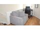 Cozy living room featuring an accent chair, hardwood floors, and a well-lit office desk at 7042 Gavin Dr, Indianapolis, IN 46217