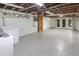 Unfinished basement with painted walls, utility connections, and doors to outside at 7061 Maryann Ct, Indianapolis, IN 46227