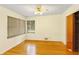 Standard bedroom with hardwood floors, ceiling fan, closet and window with blinds at 7061 Maryann Ct, Indianapolis, IN 46227