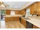 Kitchen with warm wood cabinetry, stainless steel appliances, and tile flooring at 7061 Maryann Ct, Indianapolis, IN 46227