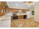 Well-lit kitchen featuring wood cabinetry, stainless steel appliances, and a white refrigerator at 7061 Maryann Ct, Indianapolis, IN 46227