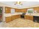 Bright kitchen featuring ample wood cabinetry, stainless steel appliances, and tiled floors at 7061 Maryann Ct, Indianapolis, IN 46227