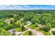 Aerial view of homes surrounded by lush greenery and trees, showcasing neighborhood and landscape at 7074 E Pine Needle Ln, Morgantown, IN 46160