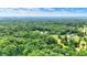 Wide aerial view showcasing a private, wooded neighborhood with lush greenery and scattered residences at 7074 E Pine Needle Ln, Morgantown, IN 46160