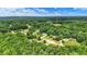 Lush aerial view showcases a private, wooded neighborhood with lush greenery and scattered residences at 7074 E Pine Needle Ln, Morgantown, IN 46160