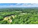 Expansive aerial view showcasing a private, wooded neighborhood with lush greenery and scattered residences at 7074 E Pine Needle Ln, Morgantown, IN 46160