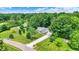 Aerial view of the property showing mature trees, a long driveway, and serene surroundings at 7074 E Pine Needle Ln, Morgantown, IN 46160