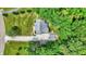 An aerial view showcases the rear exterior, gravel driveway, and lush surrounding landscaping at 7074 E Pine Needle Ln, Morgantown, IN 46160