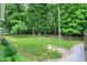 Expansive backyard featuring lush green grass and mature trees, offering ample space for outdoor activities at 7074 E Pine Needle Ln, Morgantown, IN 46160