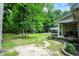 Backyard featuring lush greenery, mature trees, and an inviting covered porch at 7074 E Pine Needle Ln, Morgantown, IN 46160