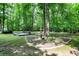 Private backyard with a beautiful water fountain, platform seating, and landscaped garden beds at 7074 E Pine Needle Ln, Morgantown, IN 46160
