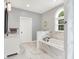 Updated bathroom with marble countertops, marble floors, and a garden tub at 7074 E Pine Needle Ln, Morgantown, IN 46160