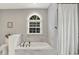 Large bathtub with marble trim and tiles and a separate shower with a shower curtain at 7074 E Pine Needle Ln, Morgantown, IN 46160