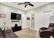 Comfortable bedroom with a ceiling fan, closet and a modern entertainment setup at 7074 E Pine Needle Ln, Morgantown, IN 46160