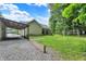 Home with a side view, covered parking area, and spacious lawn with mature trees at 7074 E Pine Needle Ln, Morgantown, IN 46160