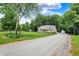 Charming home with well-manicured lawn, gravel driveway, and curb appeal at 7074 E Pine Needle Ln, Morgantown, IN 46160
