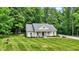 Charming home with manicured lawn, complemented by mature trees and inviting front porch at 7074 E Pine Needle Ln, Morgantown, IN 46160