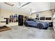 Well-organized garage with ample storage, shelving, and a modern vehicle at 7074 E Pine Needle Ln, Morgantown, IN 46160