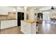 Kitchen with island seating, white cabinets, and stainless-steel appliances at 7074 E Pine Needle Ln, Morgantown, IN 46160