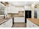 Bright kitchen featuring white cabinets, modern countertops, and stainless-steel appliances at 7074 E Pine Needle Ln, Morgantown, IN 46160