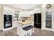 Stylish kitchen showcasing white cabinetry, a center island with seating, and modern appliances at 7074 E Pine Needle Ln, Morgantown, IN 46160