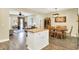Open-concept showing kitchen island, dining area, and living room at 7074 E Pine Needle Ln, Morgantown, IN 46160