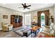 Inviting living room featuring a cozy seating area, hardwood floors, and a ceiling fan at 7074 E Pine Needle Ln, Morgantown, IN 46160
