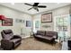 Living Room features a large reclining chair, couch, and two windows at 7074 E Pine Needle Ln, Morgantown, IN 46160