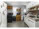 Functional kitchen with white cabinets, gas range and a vintage-style hutch at 719 Melvenia St, Indianapolis, IN 46219