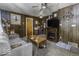 Living room with wood paneling, features a classic fireplace and entertainment setup at 719 Melvenia St, Indianapolis, IN 46219