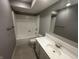 Well-lit bathroom with a clean vanity, mirror, tile flooring, and a shower-tub combination at 723 Bennett Rd, Carmel, IN 46032