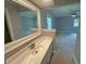 Bathroom featuring a decorative mirror, sink, and view into the bedroom at 723 Bennett Rd, Carmel, IN 46032