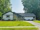 Charming single-story home with well-maintained lawn and stone accents at 723 Bennett Rd, Carmel, IN 46032