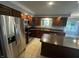 Well-equipped kitchen with stainless steel appliances, dark wood cabinets, and a center island at 723 Bennett Rd, Carmel, IN 46032